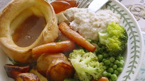 Top View of British Roast Dinner with Yorkshire Puddings, Carrots, Broccoli Stock Footage 334020125