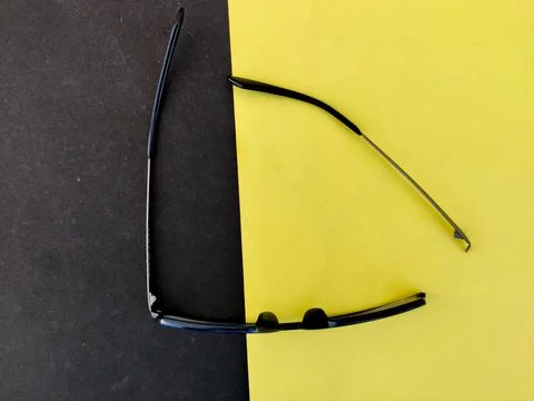 Top view of broken arm of Blue color spectacle or eyeglasses isolated on yell Stock Illustration