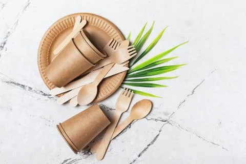Top view of brown craft disposable take-out cup, plate, and wooden fork, spoo Stock Photos