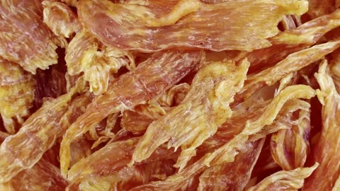 Top view of brown dried chicken breast jerky meat circle rotation close up Stock Footage 233500543