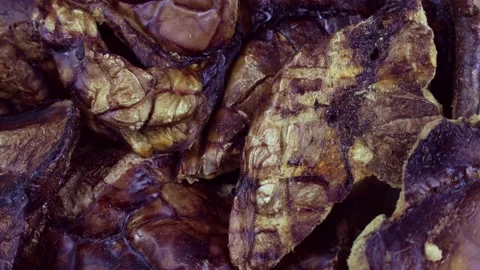 Top view of brown dried dog food or pet treat beef lung circle rotation Stock Footage 235659375