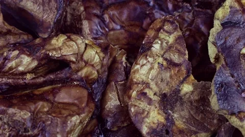 Top view of brown dried dog food or pet treat beef lung circle rotation close up Stock Footage 236143751
