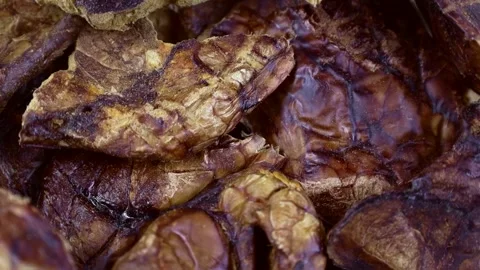 Top view of brown dried dog food or pet treat beef lung circle rotation close up Stock Footage 236932463