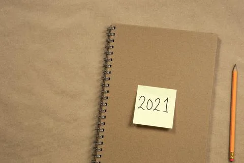 Top view of Brown notepad and yellow sticky note with 2021 New Year's message Stock Photos