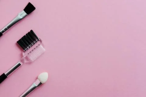 Top view brush makeup tools with pink pastel background Stock Photos