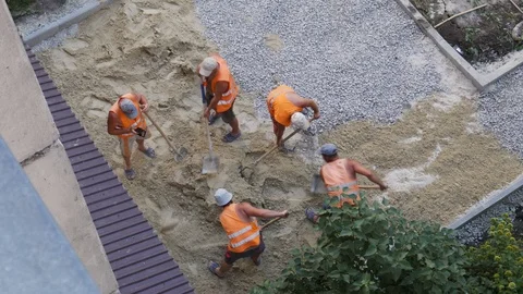 Top view. Builders throws sand with a shovel for paving stones Stock Footage 111836606