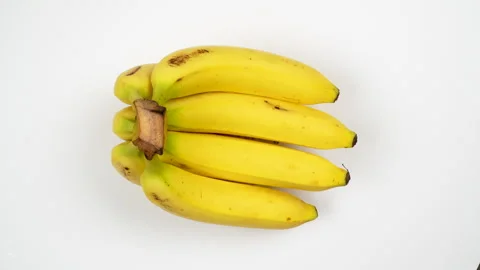Top View Bunch Of Fresh Yellow Bananas Rotating On White Background 4K Stock Footage 322146544
