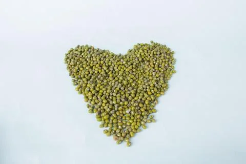 Top view of bunch of green beans forming love isolated on blue background Stock Photos