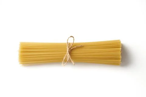 Top view of bunch of raw spaghetti pasta tied with rope isolated on white bac Stock Photos