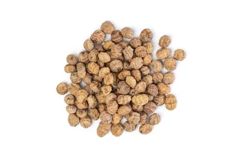 Top view of a bunch of tiger nuts on a white background. Stock Photos