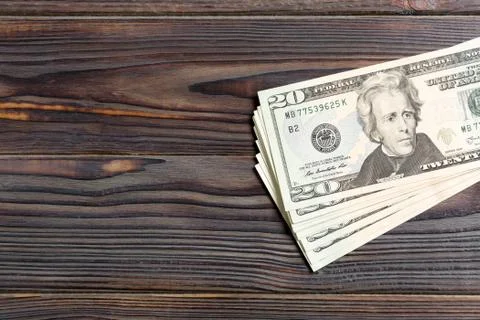 Top view of bundle of 20 dollar bill on wooden backgound. Business concept wi Stock Photos