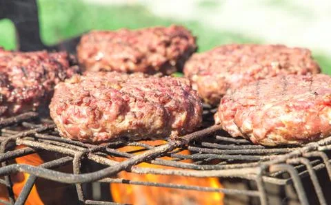 Top view of burger chops preparing on grill Stock Photos