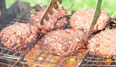 Top view of burger chops preparing on grill Stock Photos