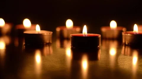 Top view of burning candles with festive bokeh on a black background Video stock 153461914