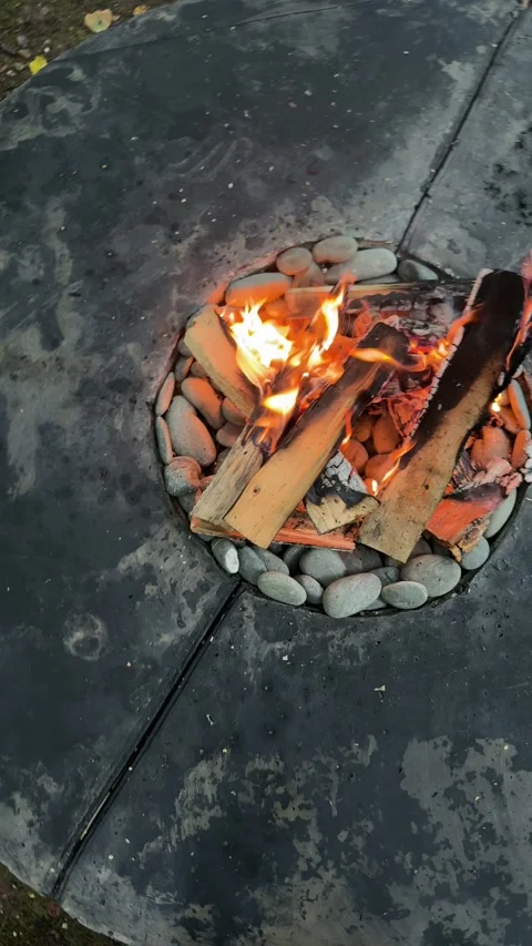 Top View of Burning Firewood in Round Outdoor Fire Pit Stock Footage 342165729