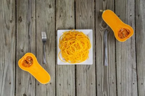 Top view of butternut squash with fork and knife. Ready to eat Stock Photos