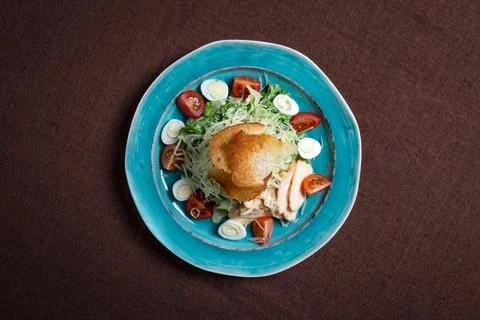 Top view of Caesar salad with chicken, fresh lettuce leaves and baked bread Stock Photos