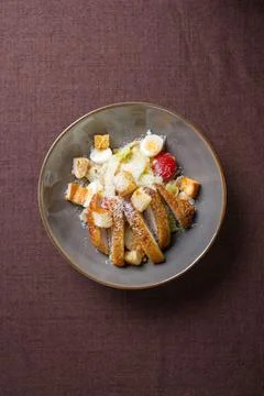 Top view Caesar salad with eggs, tomatoes and breadcrumbs and lettuce. Stock Photos