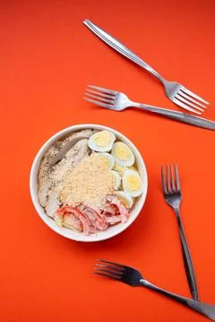 Top view of Caesar salad with lettuce, tomatoes, eggs, croutons, chicken and Stock Photos