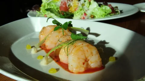Top view of Caesar salad with shrimps on the white plate and white background. Stock Footage 318464861