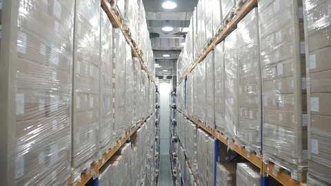 Top view camera flying through warehouse. racks with merchandise. rows shelves Video stock 123227963