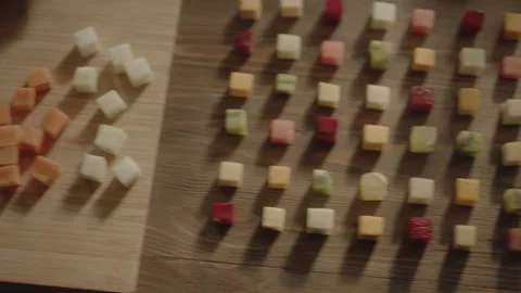 Top view the camera moves from the hands of cutting vegetables to cubes of diffe Stock Footage 143522862