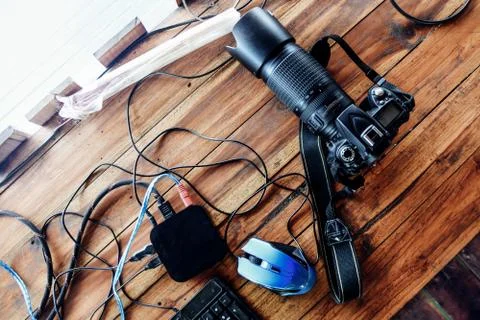 Top view of camera on wooden table and equipment for summer holiday travel co Stock Photos