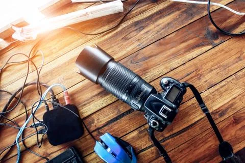 Top view of camera on wooden table and equipment for summer holiday travel co Stock Photos