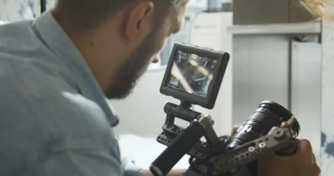 Top view on cameraman filming on set. Watching at playback Video stock 115220428