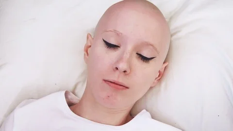 Top view of a cancer patient woman lying in the bed, wakes up and is scared and Stock Footage