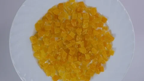 Top view candied fruit mango are rotating in a plate Stock Footage 105145912