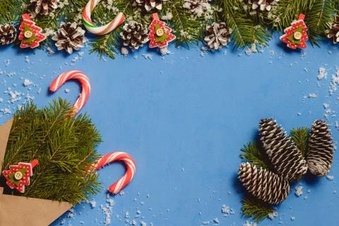 Top view candy canes and red fir tree shaped pins in brown craft envelope on Stock Photos