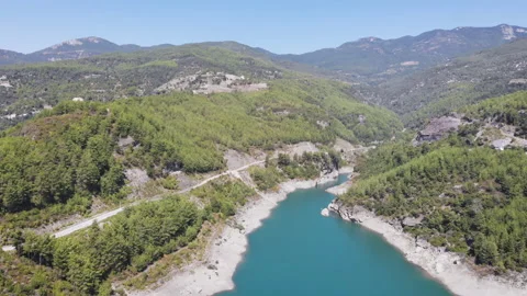 Top view on the canyon with a river in it and a road with a car driving, 4k Stock Footage 130399977