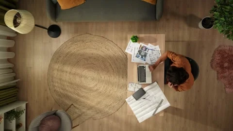 Top view capturing a man working in his home office, getting a phone call. Young Stock Footage 260054185