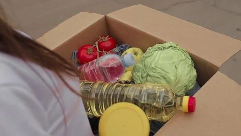 Top view, cardboard box with different food products. Safe delivery concept. Video stock 129814625