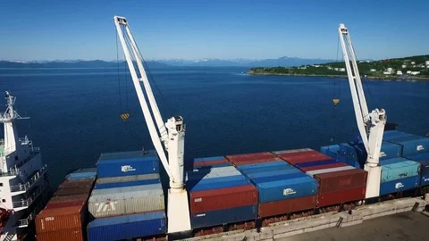 Top view of cargo ship with containers at the pier on the background of the city Stock Footage 84745894