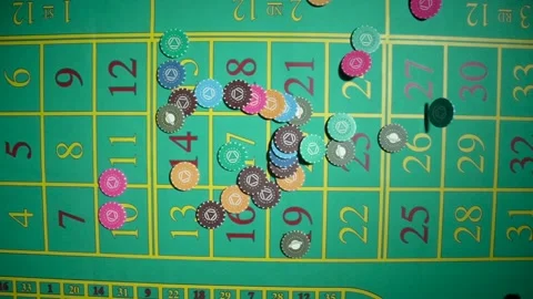 Top view of casino chips falling and scatter close up in slow motion on green Stock Footage 187552004