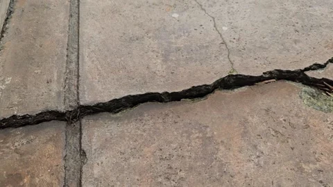 Top view of cement textured concrete ground has broken, with cracks subsidence Stock Footage 320588826