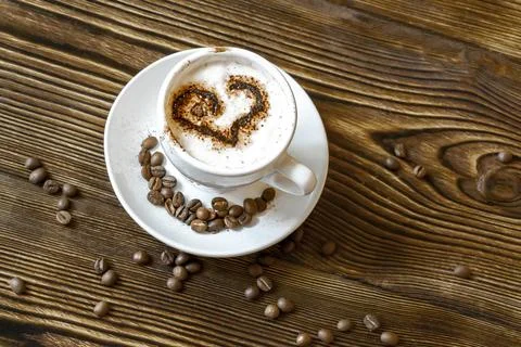 Top view of ceramic cup of hot cappuccino coffee latte with drawing picture o Stock Photos