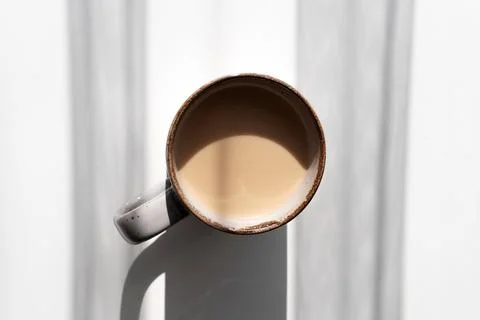 Top View of Ceramic Mug of Coffee or Tea Casting a Strong Shadow on White S.. Stock Photos