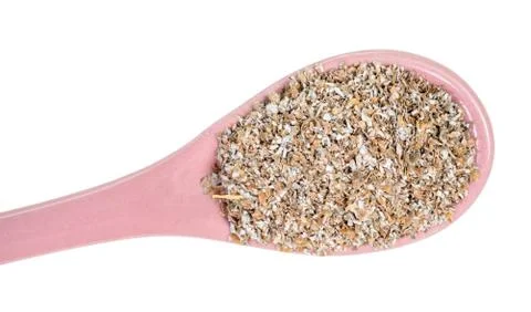 Top view of ceramic spoon with rye bran close-up Stock Photos