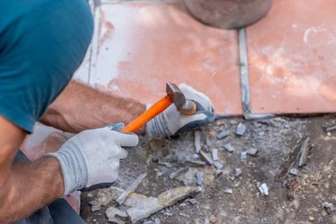 Top view of ceramic tile demolition with hammer, construction debris and ex.. Fotos Stock