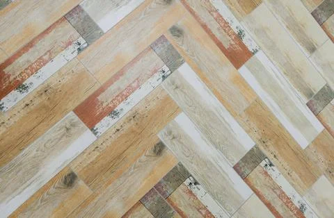 Top view of ceramic tiles with rustic wood effect in herringbone pattern. Stock Photos