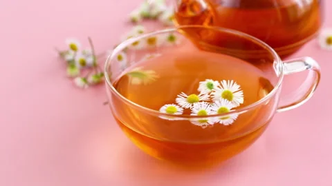 Top view of chamomile tea with flowers and pink copy space Stock Footage 342147007