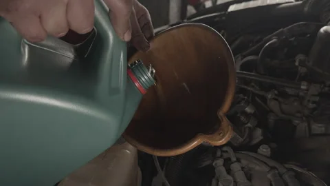 Top View of Changing Car Engine Oil and Lubricant in a Repair Shop Using a F Stock Footage 326010296