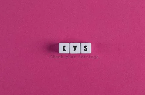 A top view of check your settings (CYS) banner with block letters on pink bac Foto stock