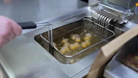 Top view cheese balls are being fried in the boiling oil. Oil is boiling over Vidéo 250465632