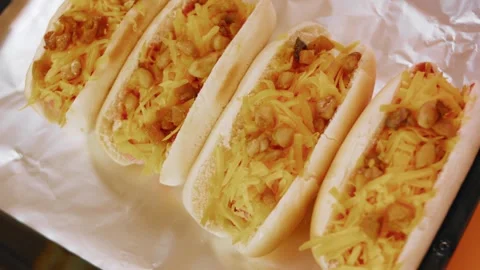Top view of cheese hot dogs in a foil-lined pan, 4K Stock Footage 341122081