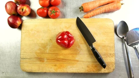 Top view chef cuts bulgarian pepper into slices on a cutting board Stock Footage 76092437