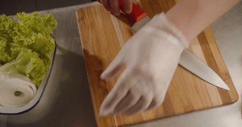 Top view chef cuts fresh tomato with sharp knife on wooden board Stock Footage 113869864
